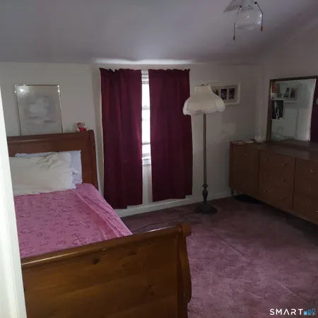a bathroom with a toilet a sink and curtain