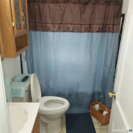 a kitchen with stainless steel appliances a refrigerator a sink a stove and white cabinets