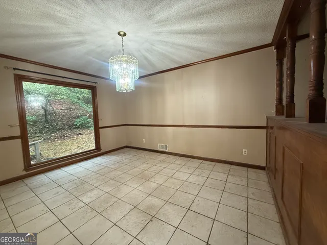 a view of a livingroom with an empty space and a window