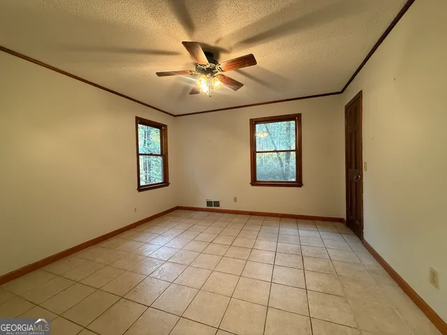 a view of an empty room with windows