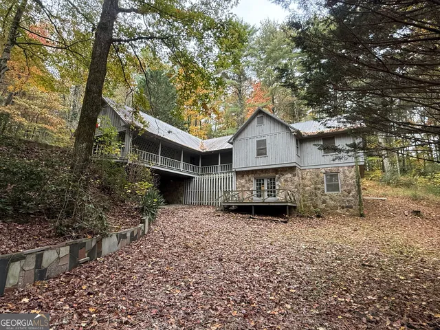 a view of a house with a tree in the yard