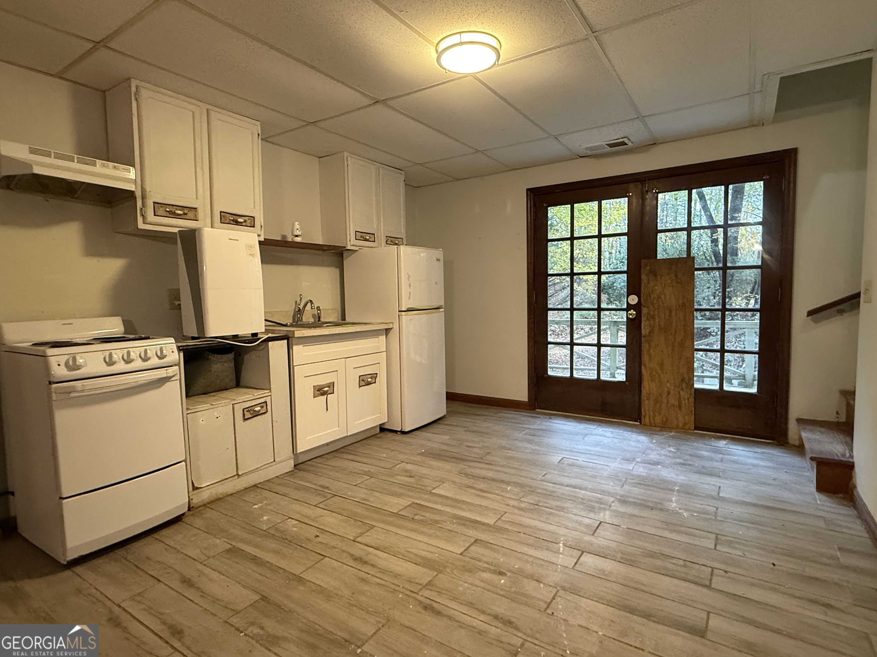 3197 Bridge Creek Road Tiger, GA 30576 - Photo 21 of 30 a kitchen with white cabinets and white appliances