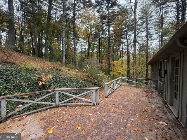 a view of a yard with wooden fence