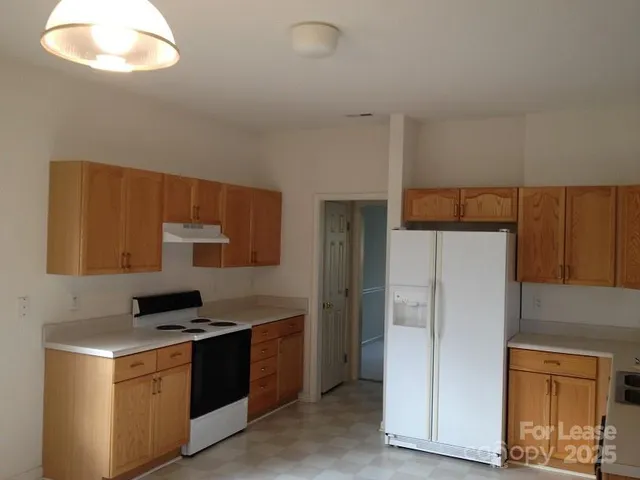 a kitchen with stainless steel appliances a refrigerator and a stove