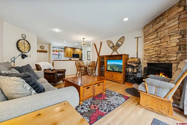 a living room with furniture a rug and a fireplace