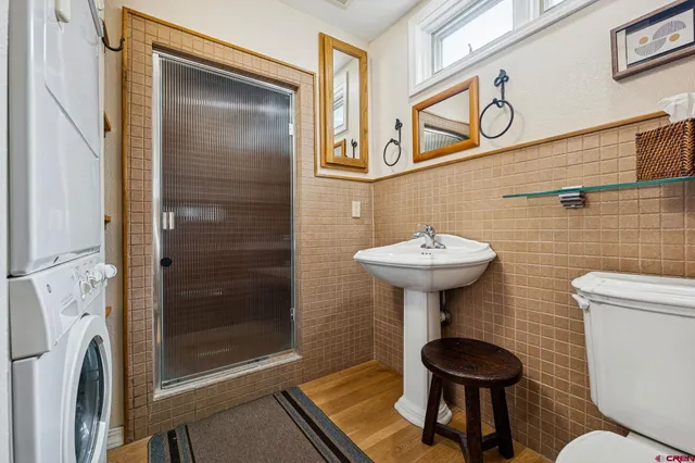 a bathroom with a sink a toilet and shower