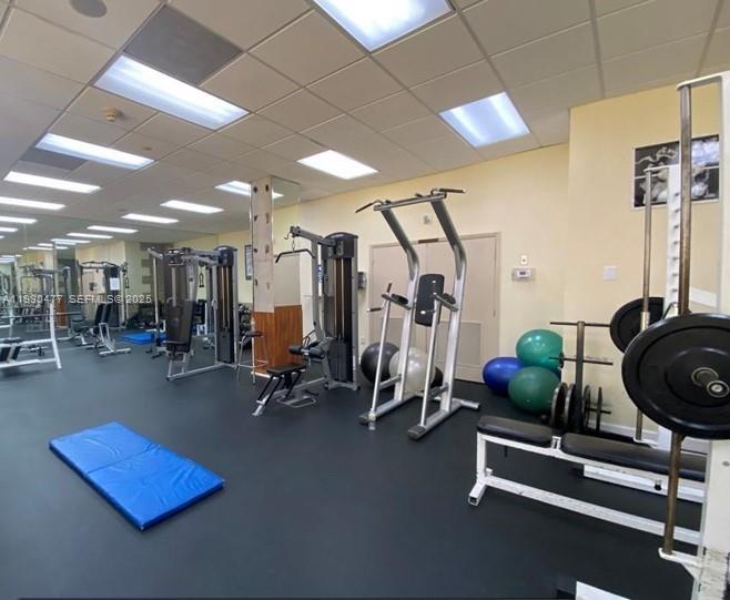 1450 Brickell Bay Drive, Unit 1606 Miami, FL 33131 - Photo 12 of 39 a room with gym equipment and windows