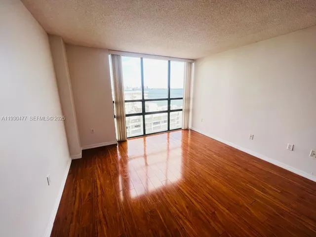 wooden floor in a hall with an empty room