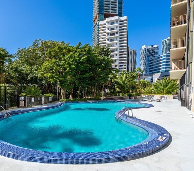 1450 Brickell Bay Drive, Unit 1606 Miami, FL 33131 - Photo 32 of 39 a view of a swimming pool with a yard