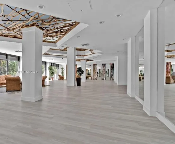 a bedroom with furniture toys and a large window