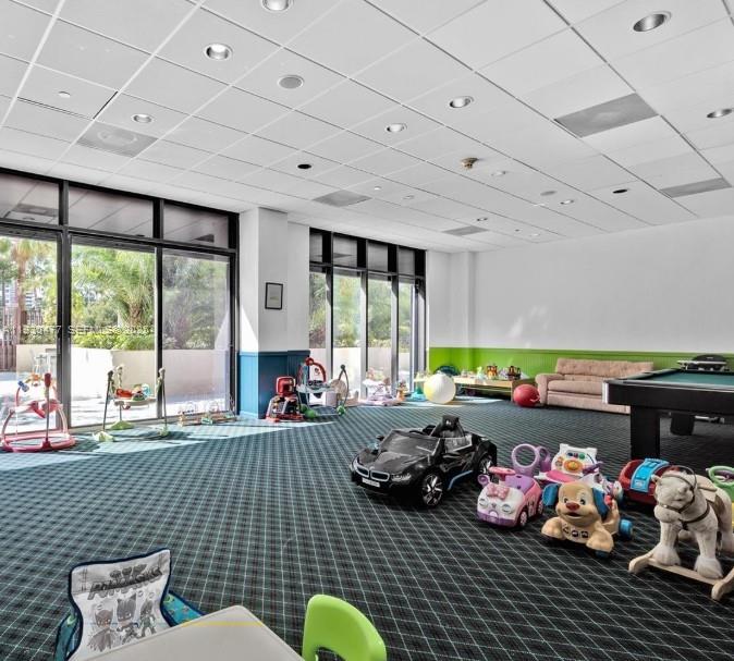 1450 Brickell Bay Drive, Unit 1606 Miami, FL 33131 - Photo 37 of 39 a bedroom with furniture toys and a large window