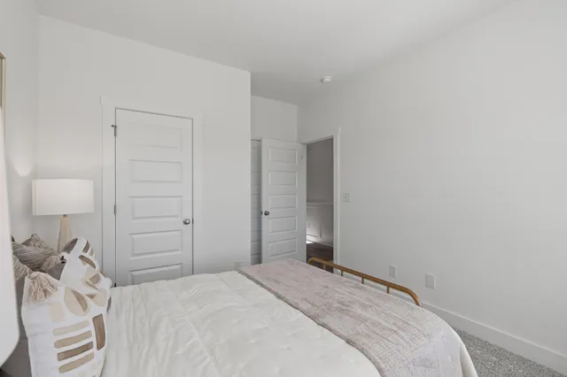 a bedroom with a bed and a lamp