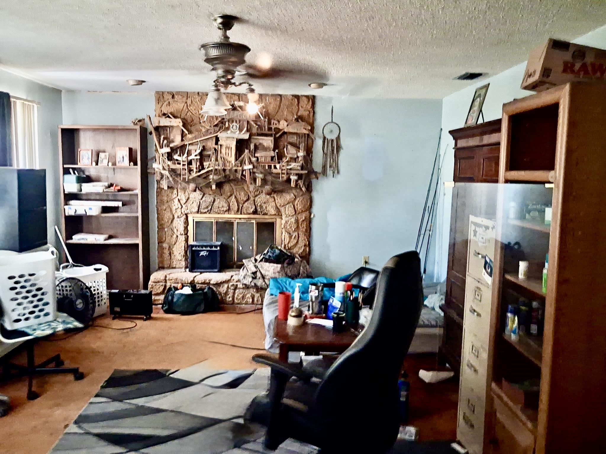 554 Hayley Road St. Augustine, FL 32086 - Photo 15 of 46 a living room with furniture a chandelier and a fireplace