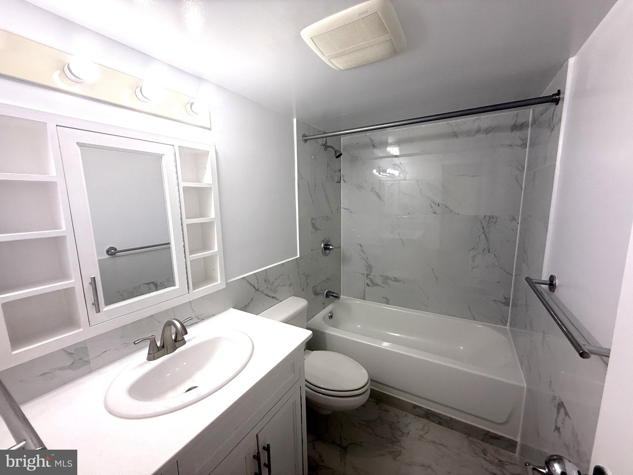 606 Cooper Landing Road, Unit B2K Cherry Hill, NJ 08002 - Photo 14 of 21 a bathroom with a bathtub shower sink vanity and toilet