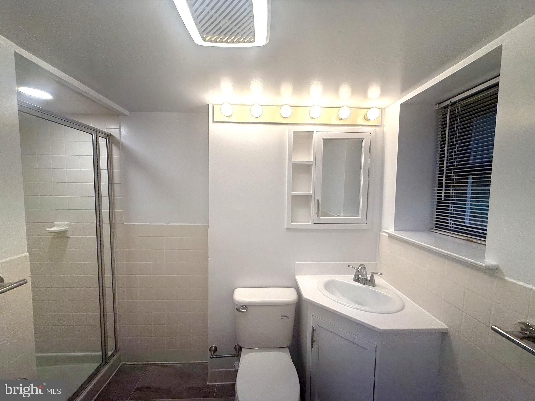 606 Cooper Landing Road, Unit B2K Cherry Hill, NJ 08002 - Photo 18 of 21 a bathroom with a toilet sink and mirror