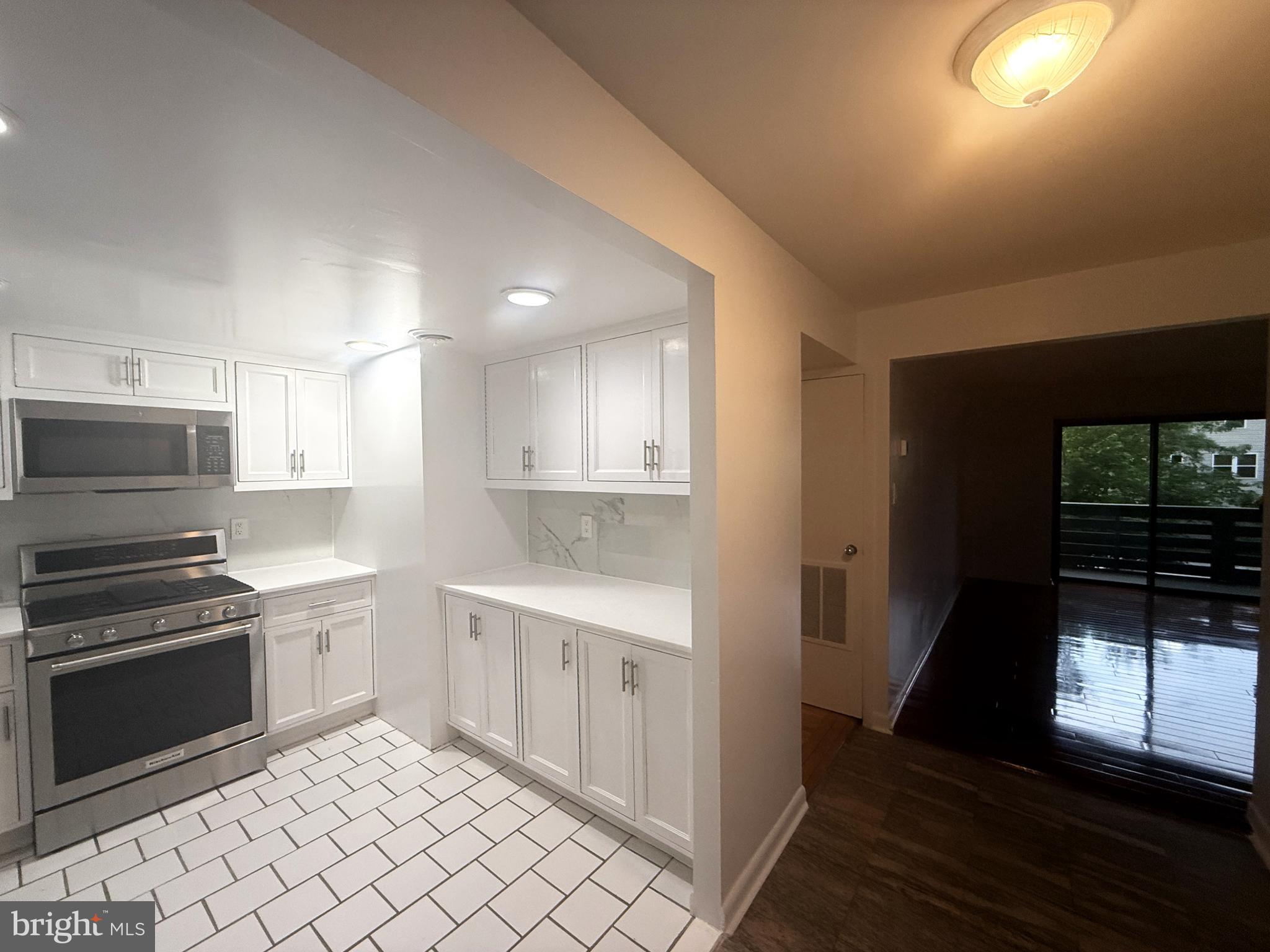 606 Cooper Landing Road, Unit B2K Cherry Hill, NJ 08002 - Photo 3 of 21 a kitchen with a sink a stove and cabinets