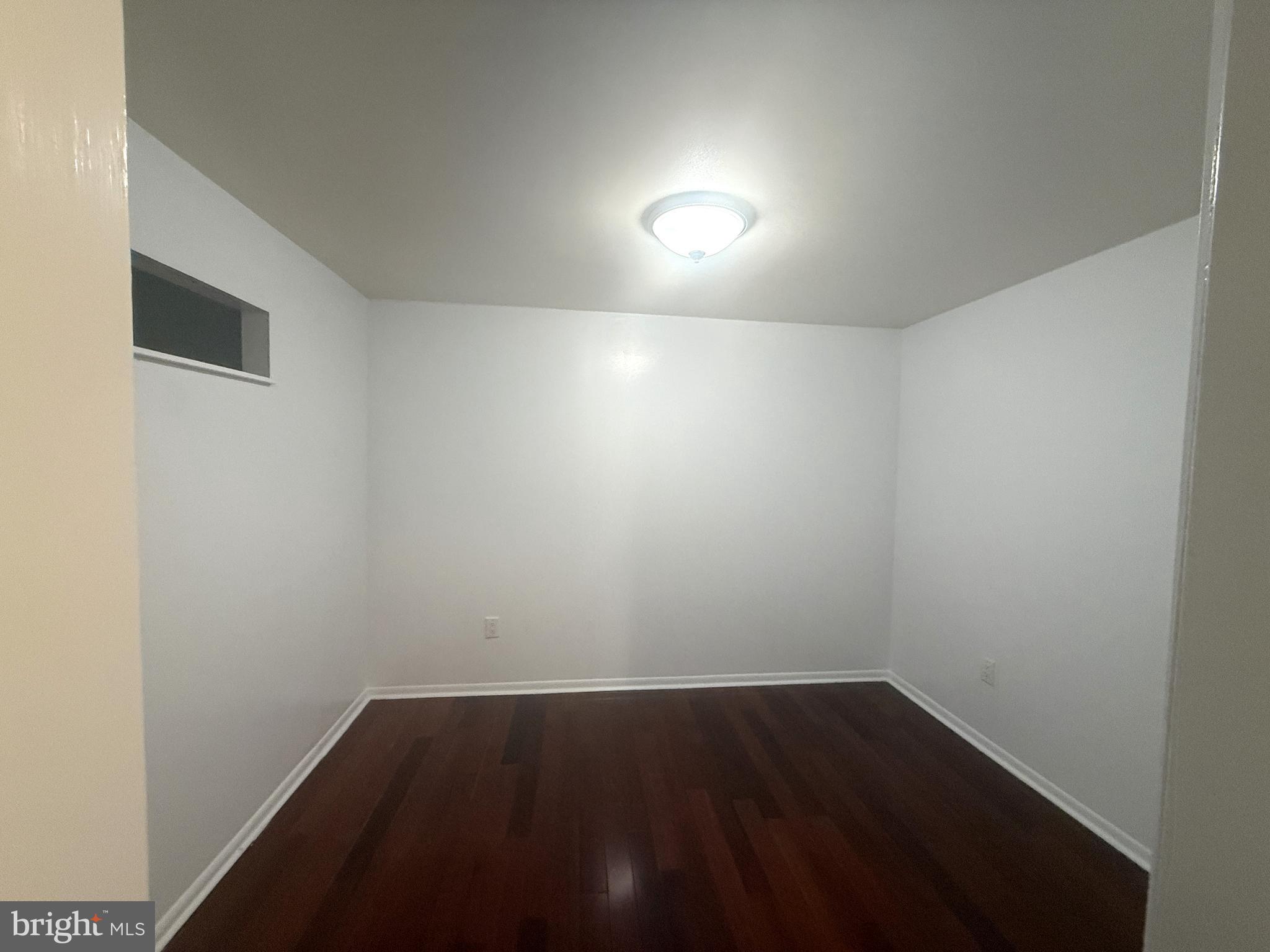 606 Cooper Landing Road, Unit B2K Cherry Hill, NJ 08002 - Photo 7 of 21 an empty room with wooden floor and windows