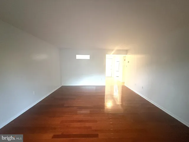 a view of an empty room and wooden floor