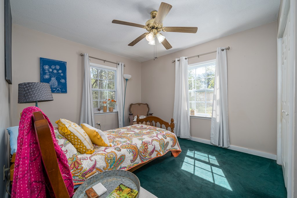 1813 John Smith Road East Blairsville, GA 30512 - Photo 20 of 41 a bedroom with a bed bookshelf and a window