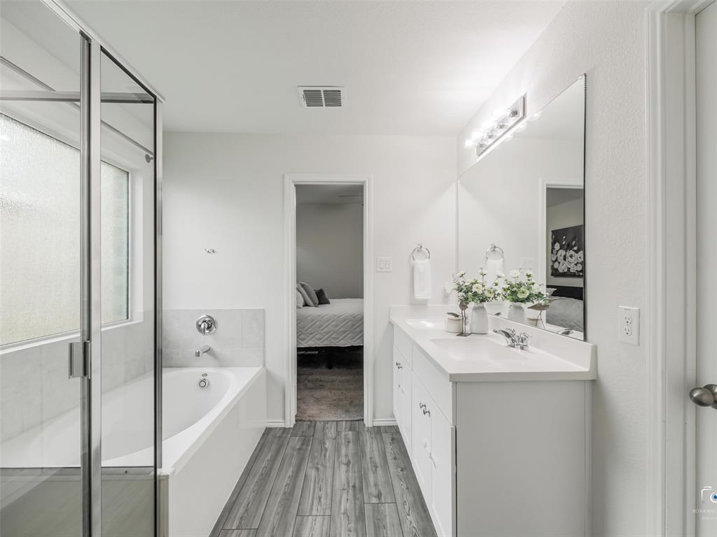 4517 Ashmark Road Aubrey, TX 76227 - Photo 15 of 26 a en suite bathroom with a tub sink and mirror