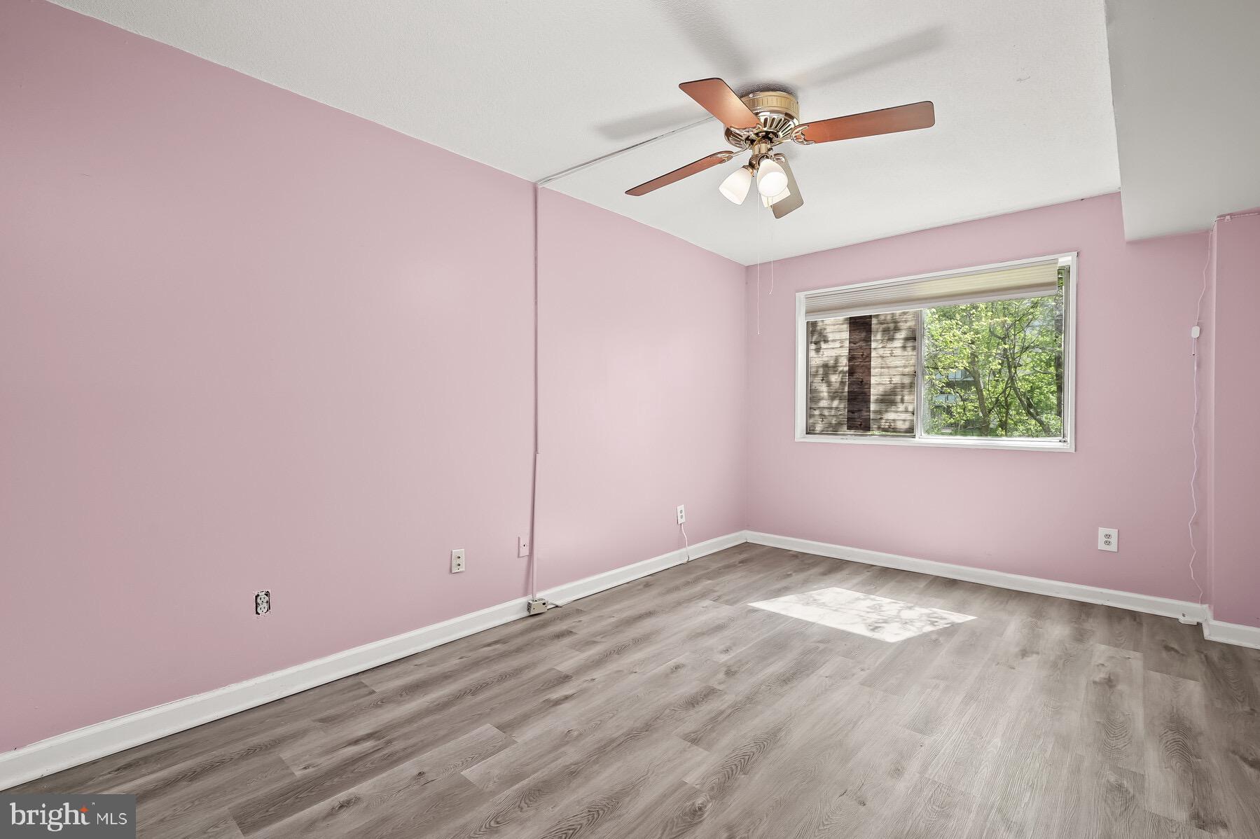 1836 Metzerott Road, Unit G3 Adelphi, MD 20783 - Photo 8 of 19 an empty room with ceiling fan and windows