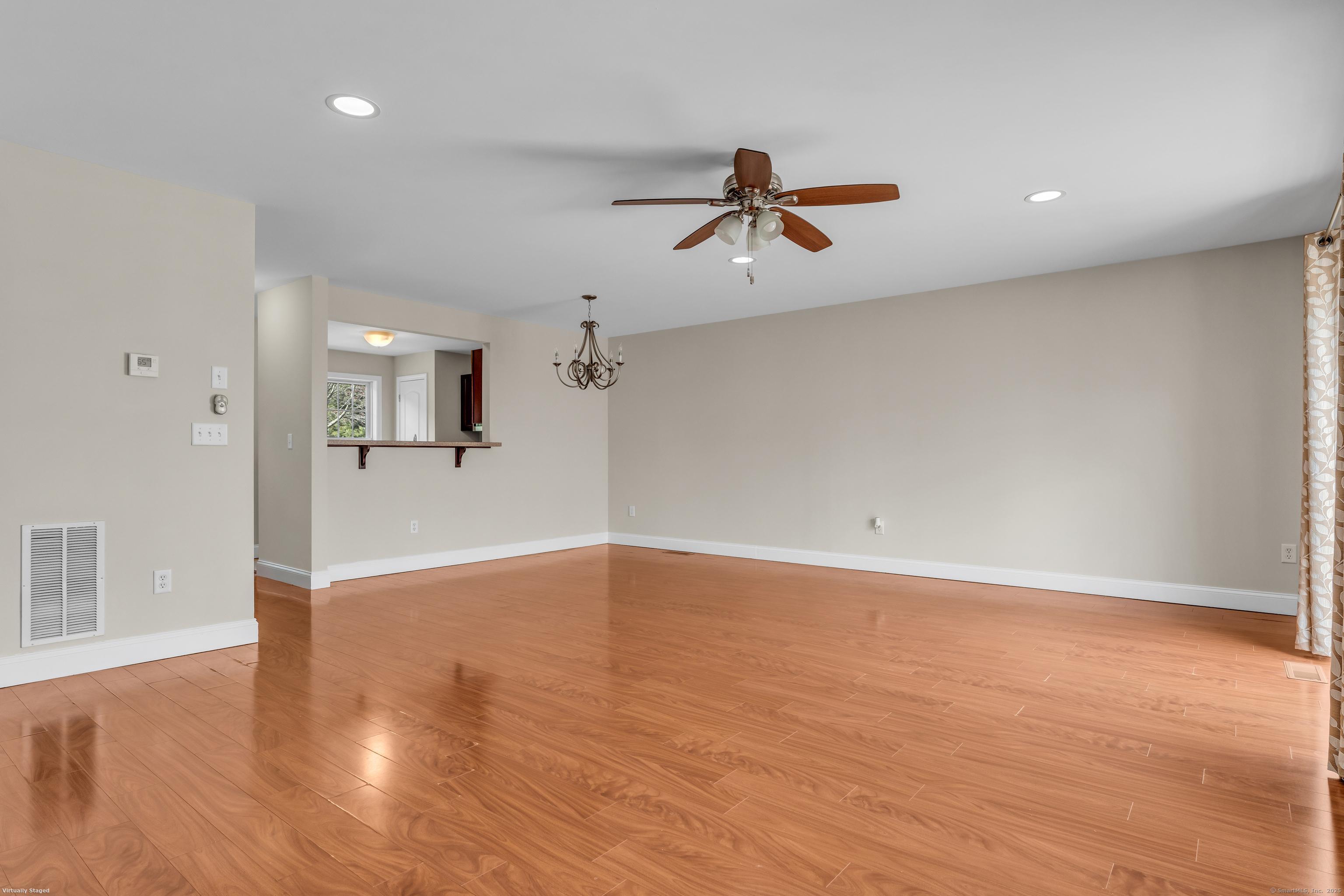 15 Freedom Way, Unit 92 Niantic, CT 06357 - Photo 11 of 33 an empty room with wooden floor and windows