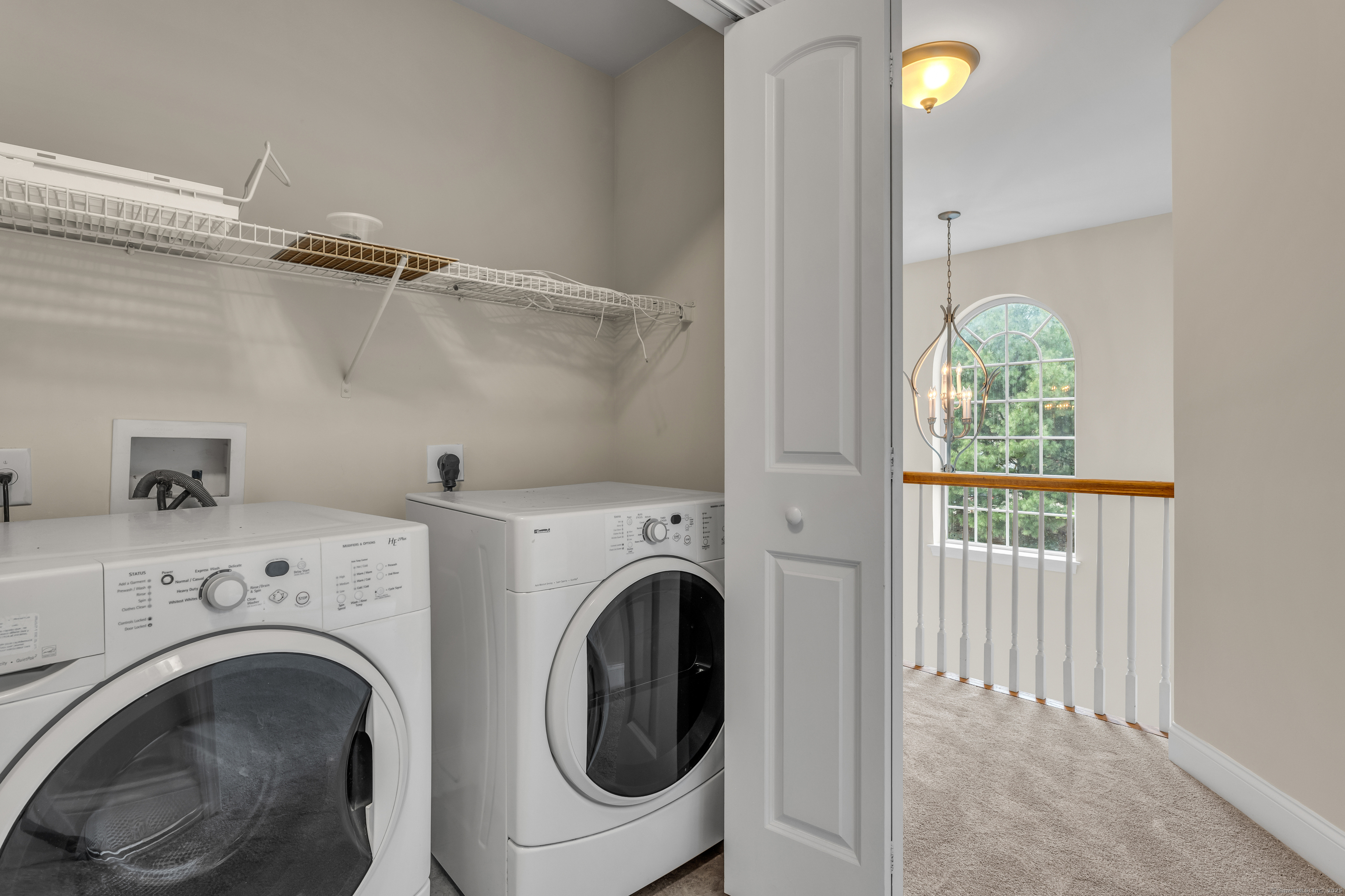 15 Freedom Way, Unit 92 Niantic, CT 06357 - Photo 19 of 33 a view of a hallway with washer and dryer