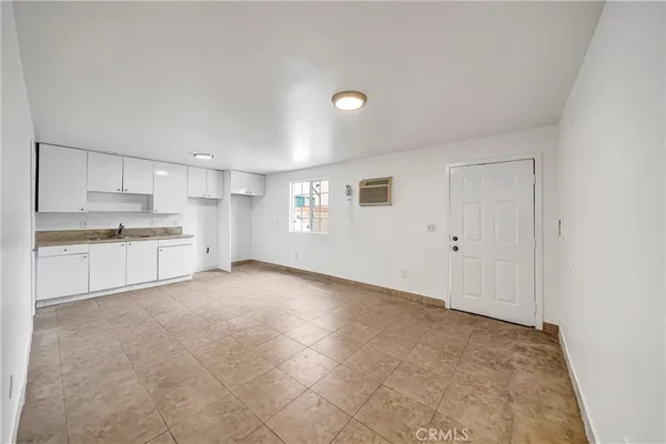 a view of a kitchen with a sink and dishwasher cabinets