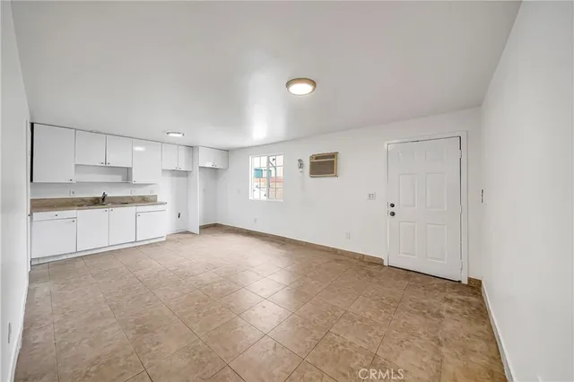 a view of a kitchen with a sink and dishwasher cabinets
