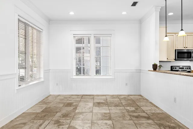 a view of a kitchen with wooden floor and a window
