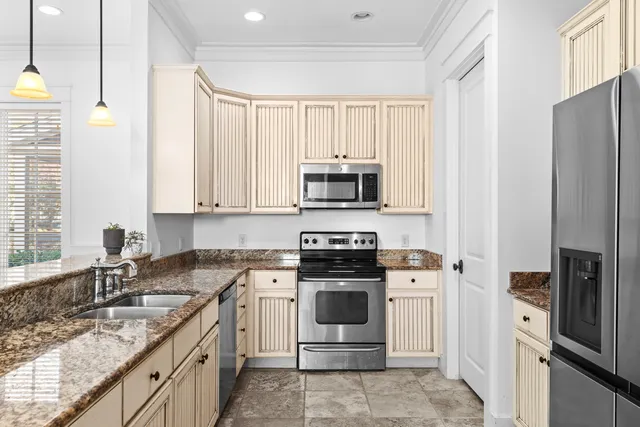 a kitchen with a sink stove and refrigerator
