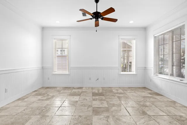 a view of empty room with ceiling fan