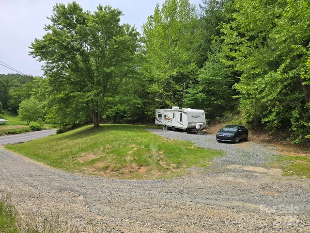 a car parked in front of a house with trees