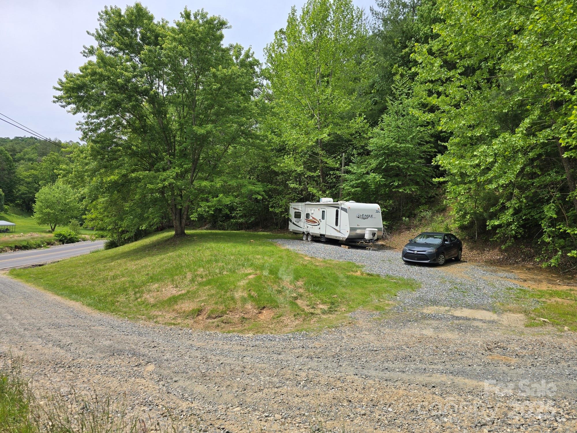 a car parked in front of a house with trees