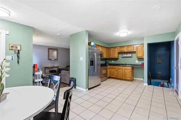 a kitchen with stainless steel appliances a refrigerator and a stove top oven
