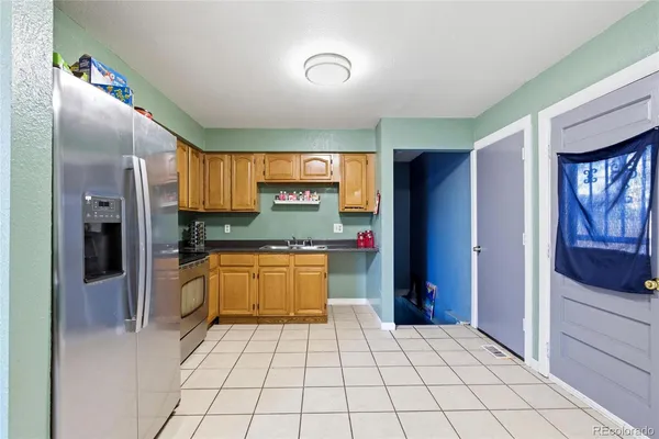 a kitchen with stainless steel appliances granite countertop a refrigerator and a stove top oven