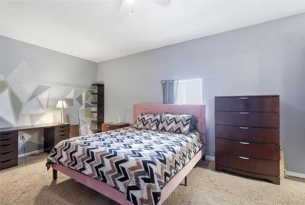 a bedroom with a bed and window