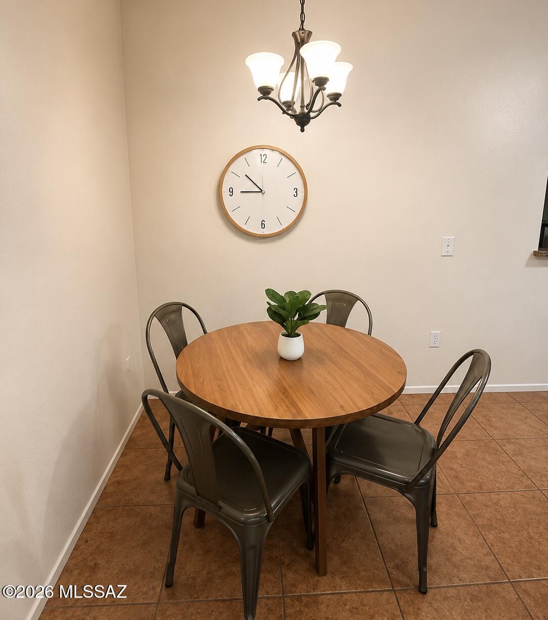 2018 East River Road, Unit 102 Tucson, AZ 85718 - Photo 12 of 25 a view of a dining room with furniture and a chandelier
