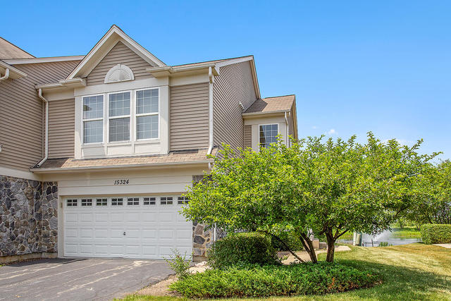 15324 Pinewood Road Lockport, IL 60441 - Photo 1 of 18 a front view of a house with a yard and garage