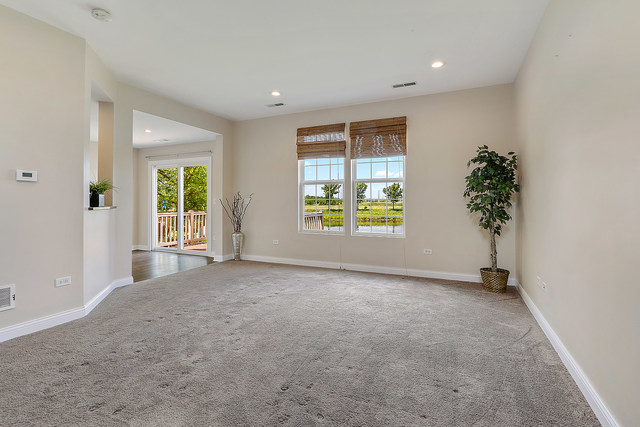 15324 Pinewood Road Lockport, IL 60441 - Photo 3 of 18 an empty room with windows and a ceiling fan