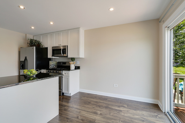 15324 Pinewood Road Lockport, IL 60441 - Photo 7 of 18 a kitchen with a sink a microwave a refrigerator and cabinets