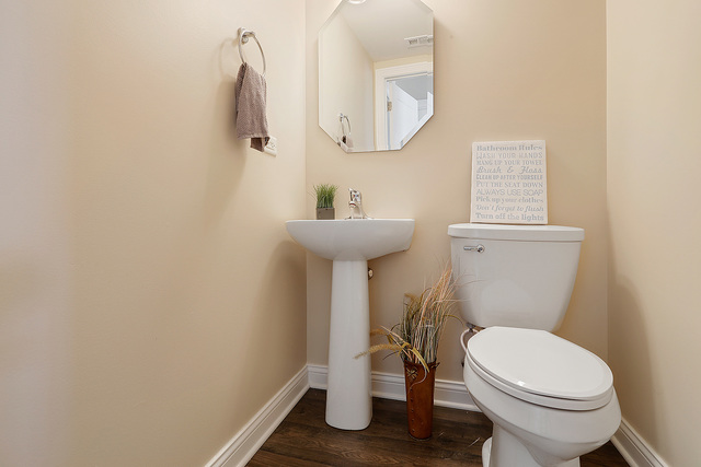 15324 Pinewood Road Lockport, IL 60441 - Photo 8 of 18 a white toilet sitting next to a bathroom sink