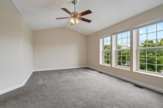 15324 Pinewood Road Lockport, IL 60441 - Photo 10 of 18 an empty room with windows and ceiling fan