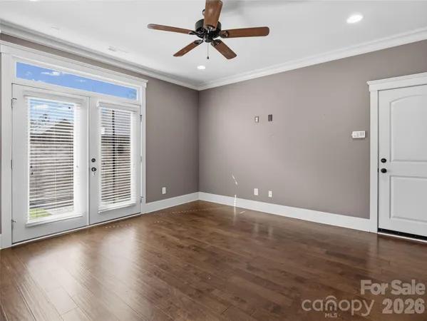 a spacious bathroom with a granite countertop sink a mirror a shower and vanity