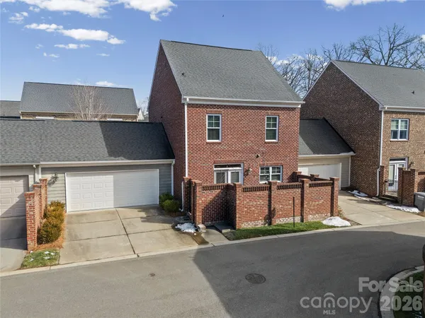 a kitchen with stainless steel appliances granite countertop a refrigerator a sink dishwasher a stove and white cabinets
