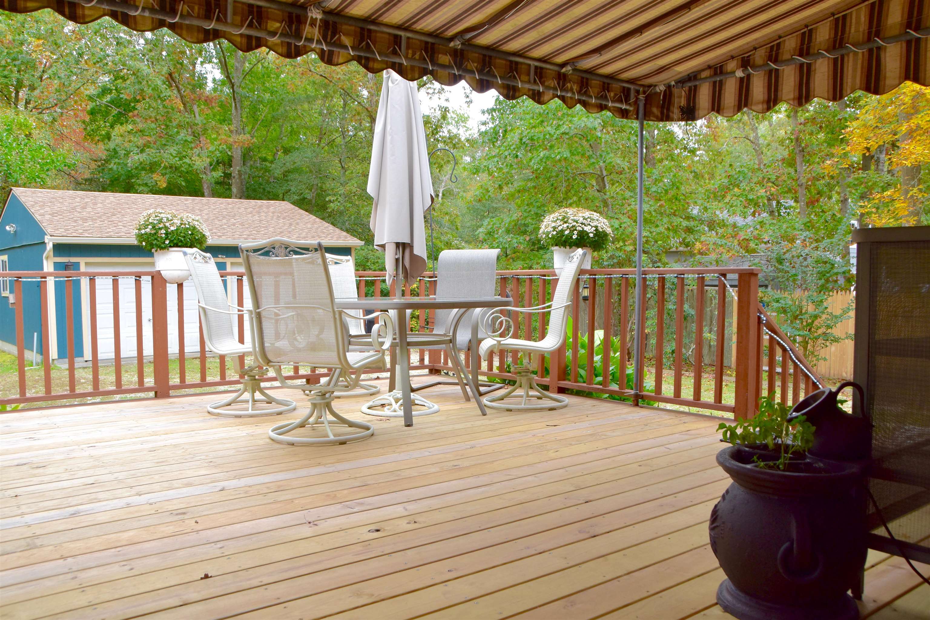 91 Tyler Road Ocean View, NJ 08230 - Photo 25 of 34 a view of a patio with table and chairs potted plants with wooden floor and fence