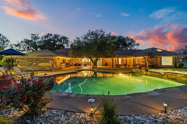 an aerial view of a house having swimming pool garden and patio