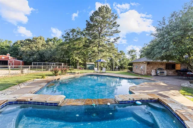 a view of a swimming pool with a patio