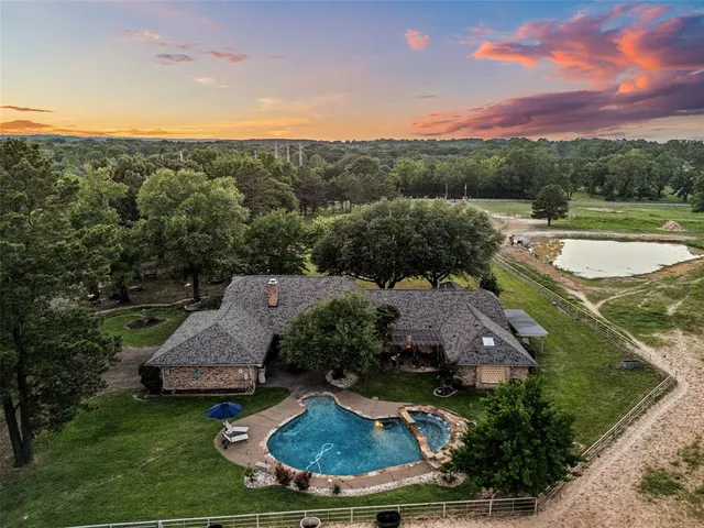 an aerial view of a house with outdoor space