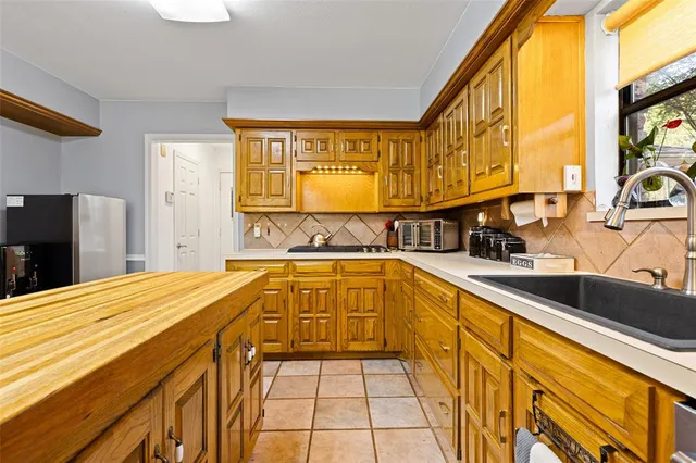 a spacious bathroom with a tub a sink and a large window